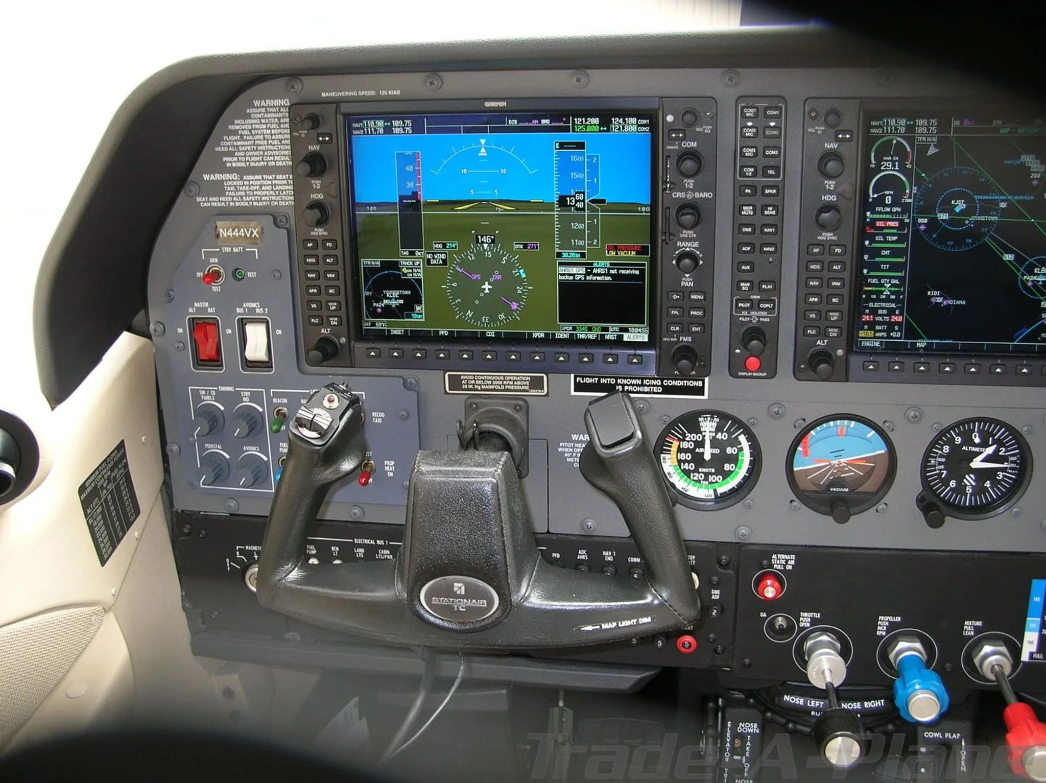 A wide view of the Cessna Stationair TC cockpit, showing the dual Garmin G1000 displays and control yokes.