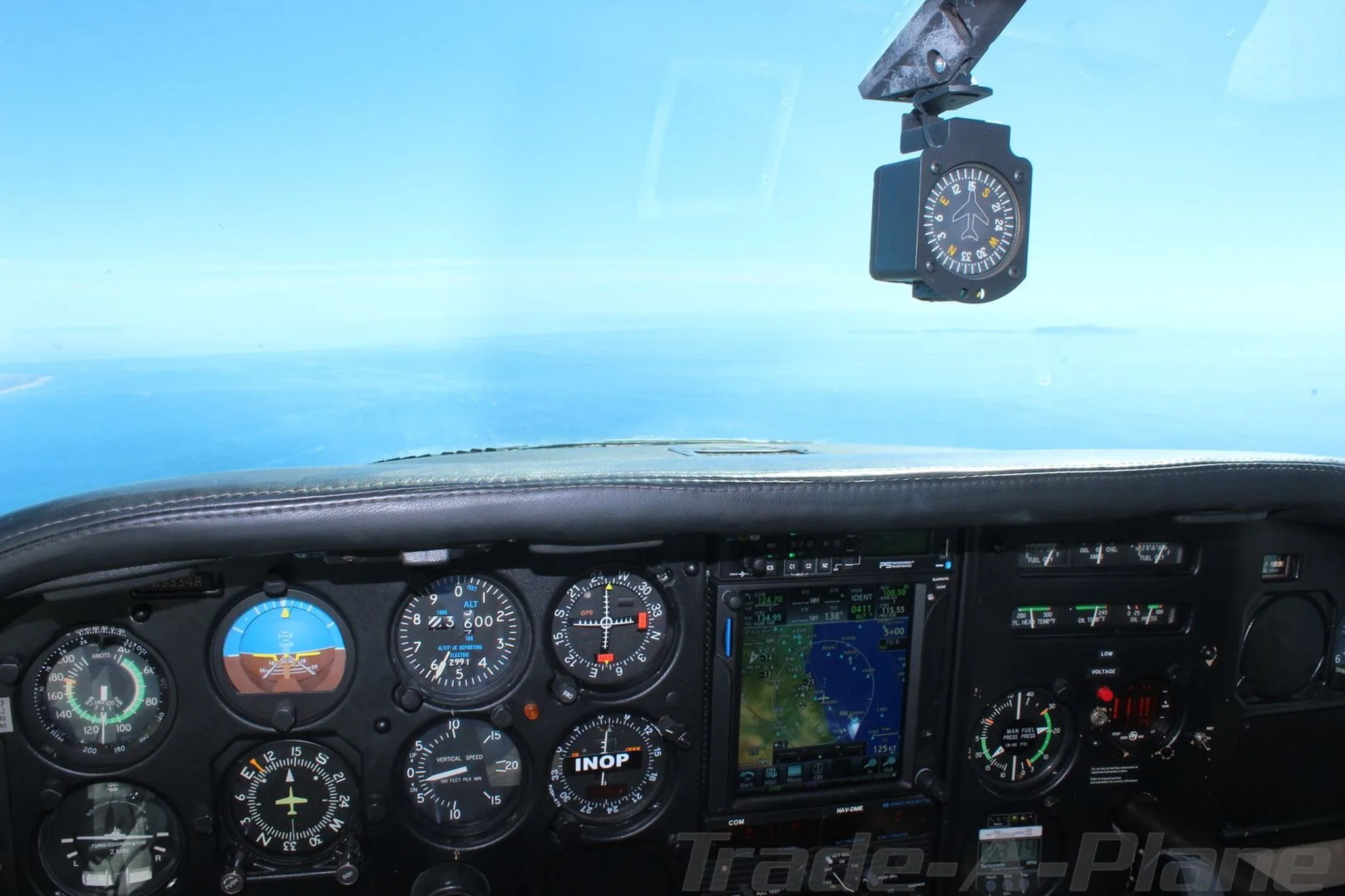 Cockpit view showing instruments and navigation display.