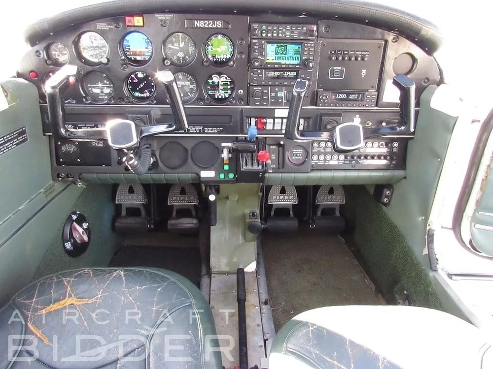 The cockpit instrument panel of the Piper Arrow 200 (N822JS) with various gauges, avionics, and controls.