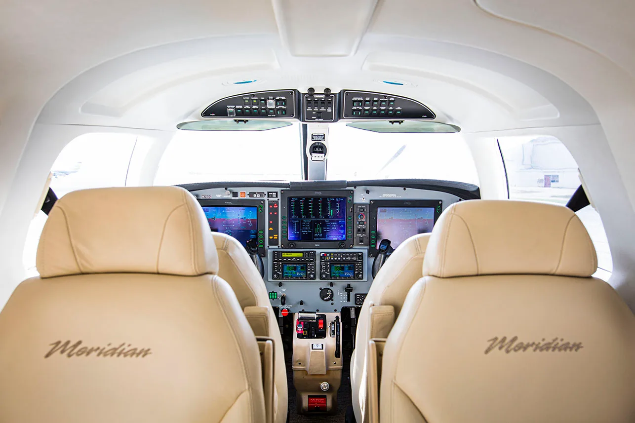 View of the cockpit from the rear seats of a Meridian aircraft.