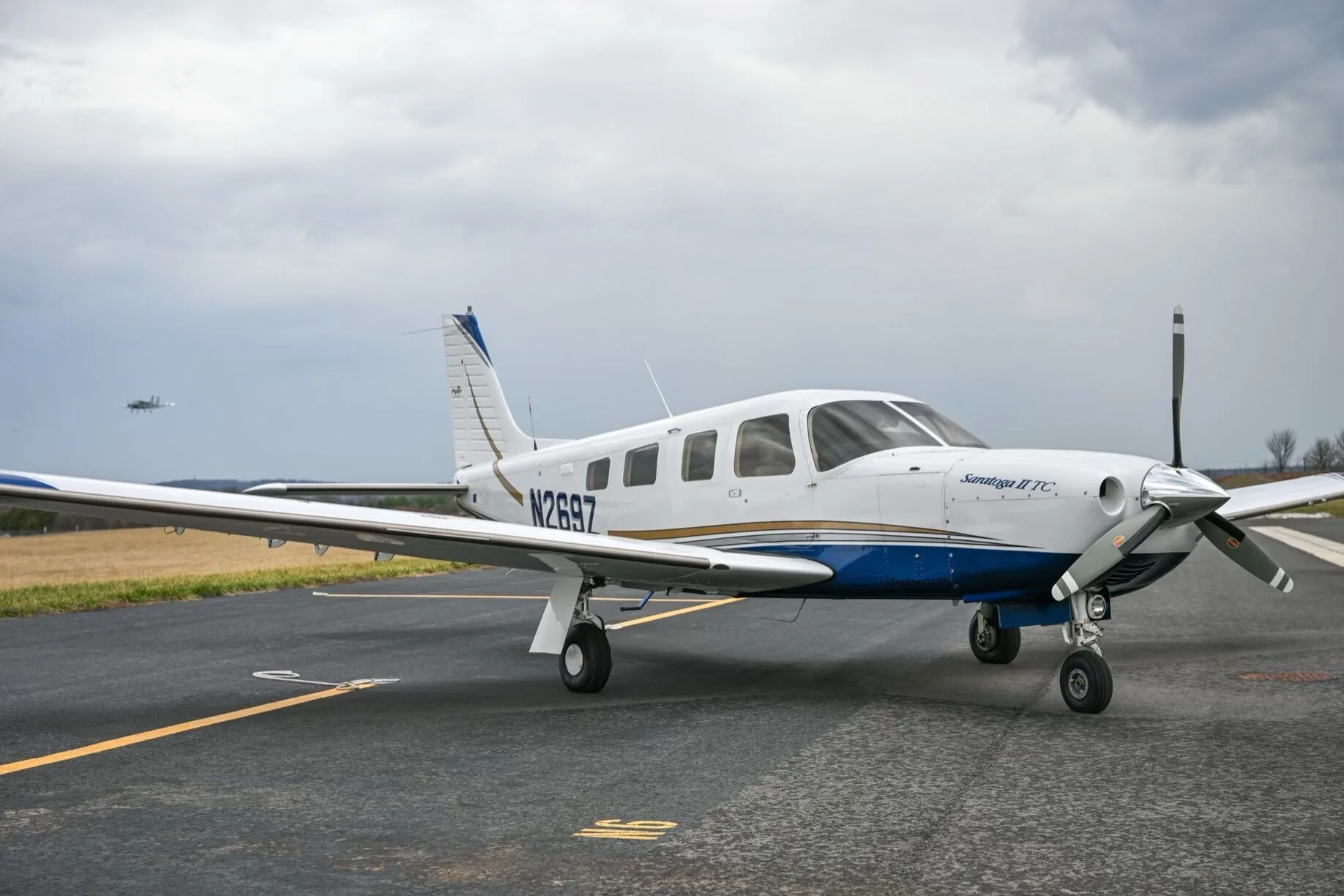 A three-quarter front view of a white Piper Saratoga II TC aircraft, tail number N269Z, parked on an airport tarmac.