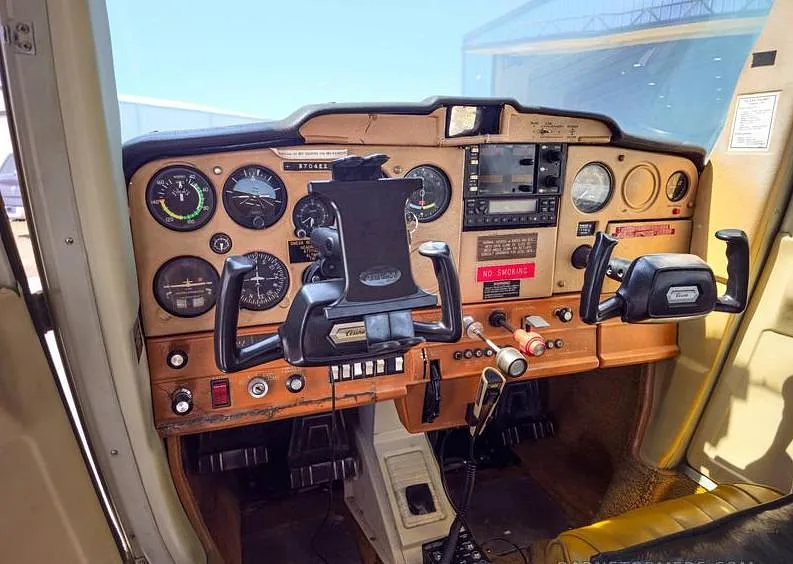 The instrument panel and dual yokes in the cockpit of a Cessna 150.