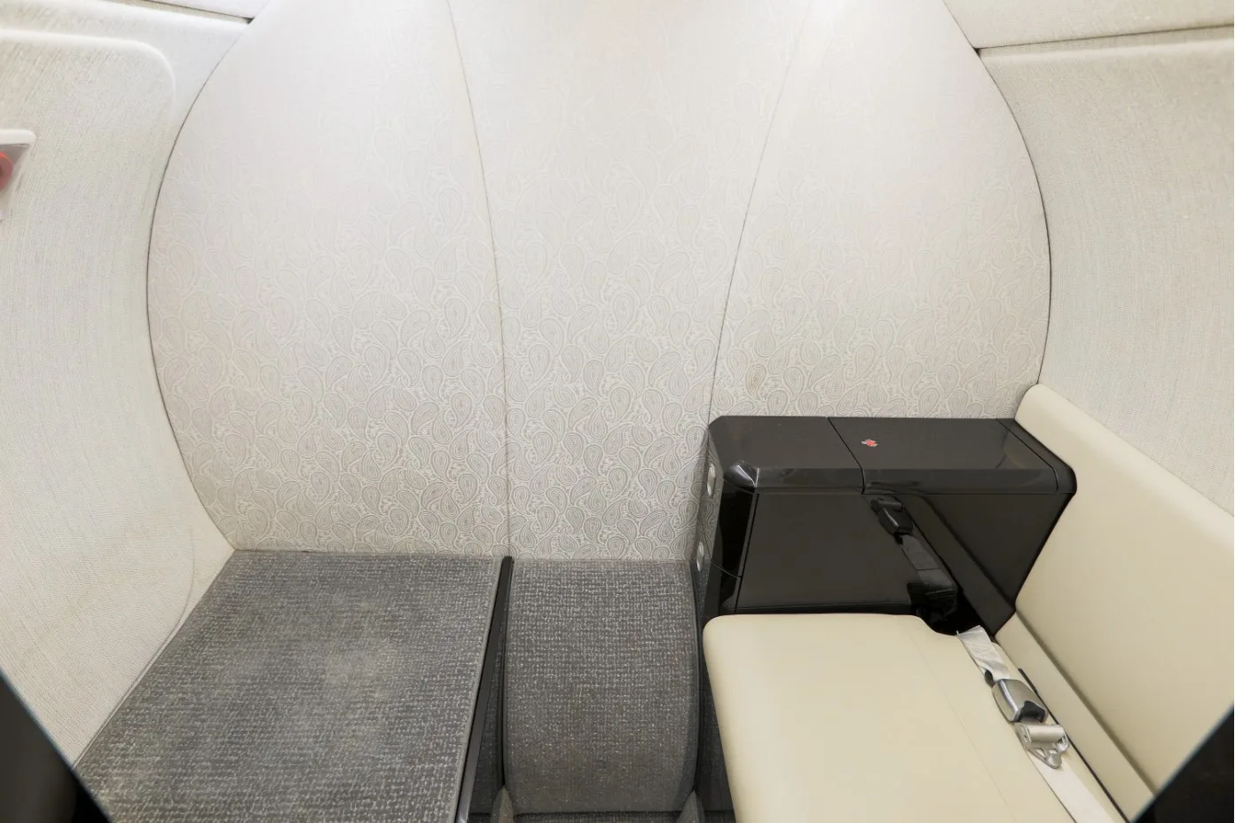 A close-up of the aircraft's interior, showing the seating and side table.