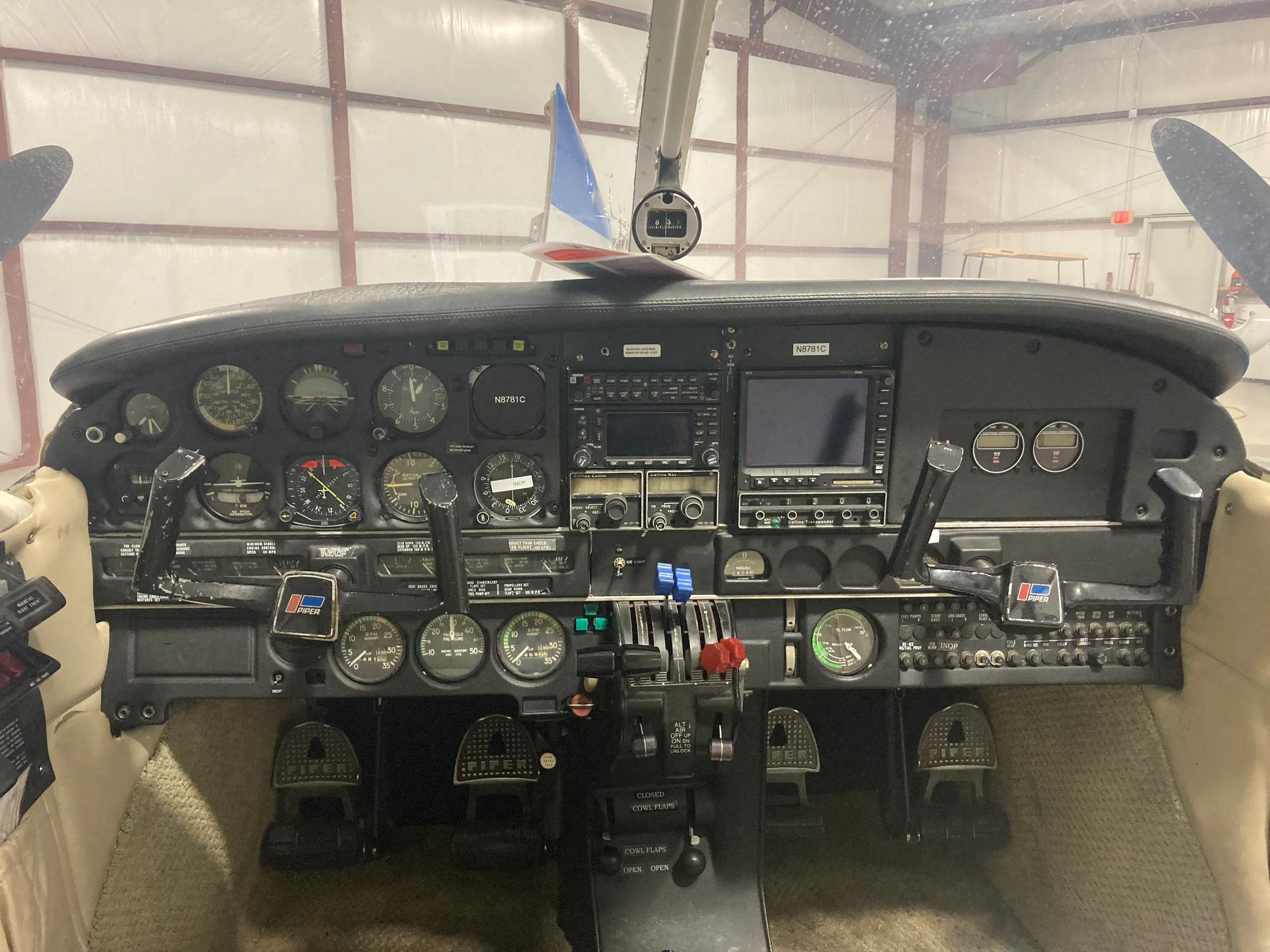 The cockpit instrument panel of a Piper Seneca, showing various gauges, avionics, and controls.
