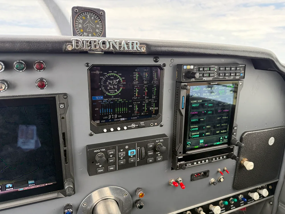 A close-up view of the modern glass cockpit of a Beechcraft Debonair, showing various digital displays and controls.