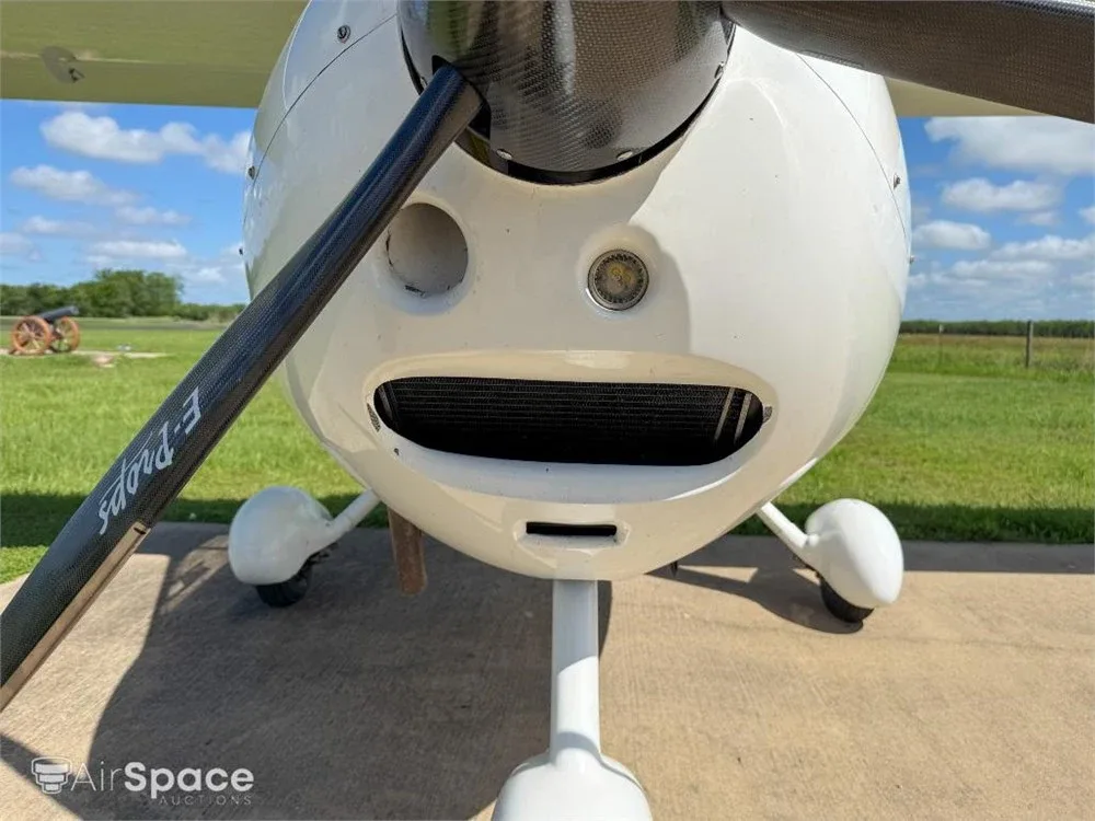 A close-up view of the white nose and propeller of the Flight Design CT Light Sport aircraft.