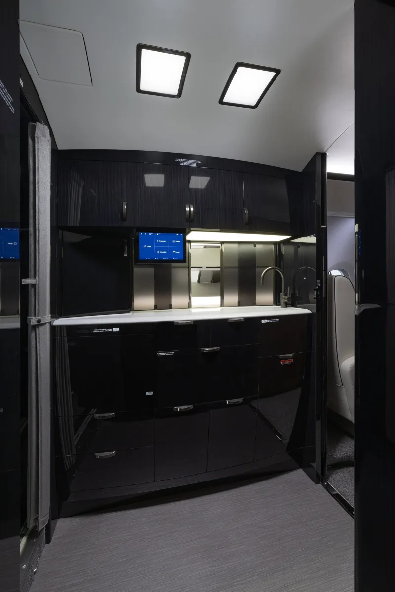 Interior view of the aircraft galley with sink and cabinets.