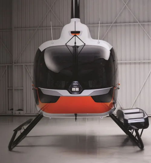 Front view of a Robinson helicopter in a hangar.