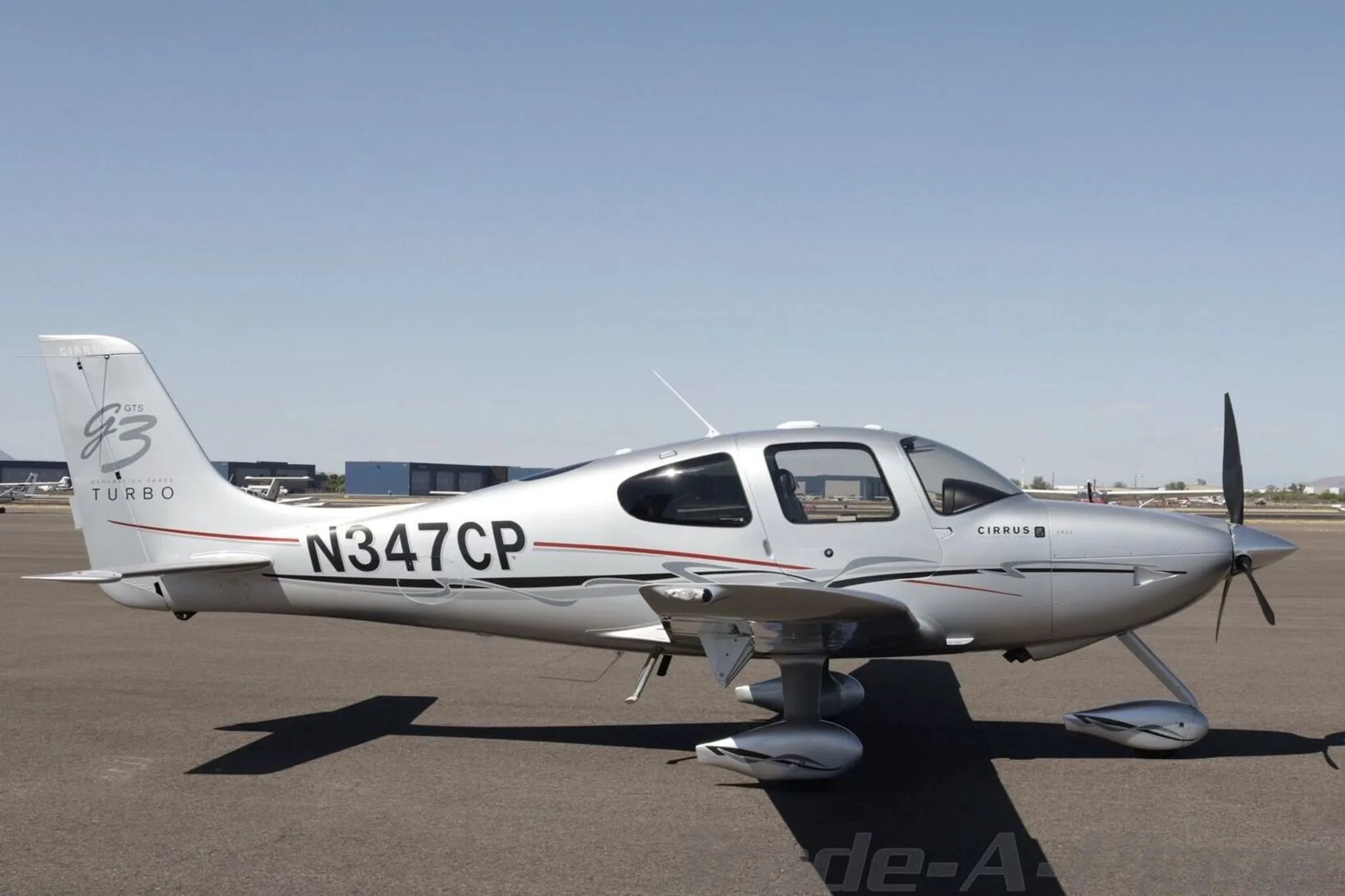 A silver Cirrus SR22 GTS Generation Three Turbo aircraft, registration N347CP, parked on an airport tarmac.