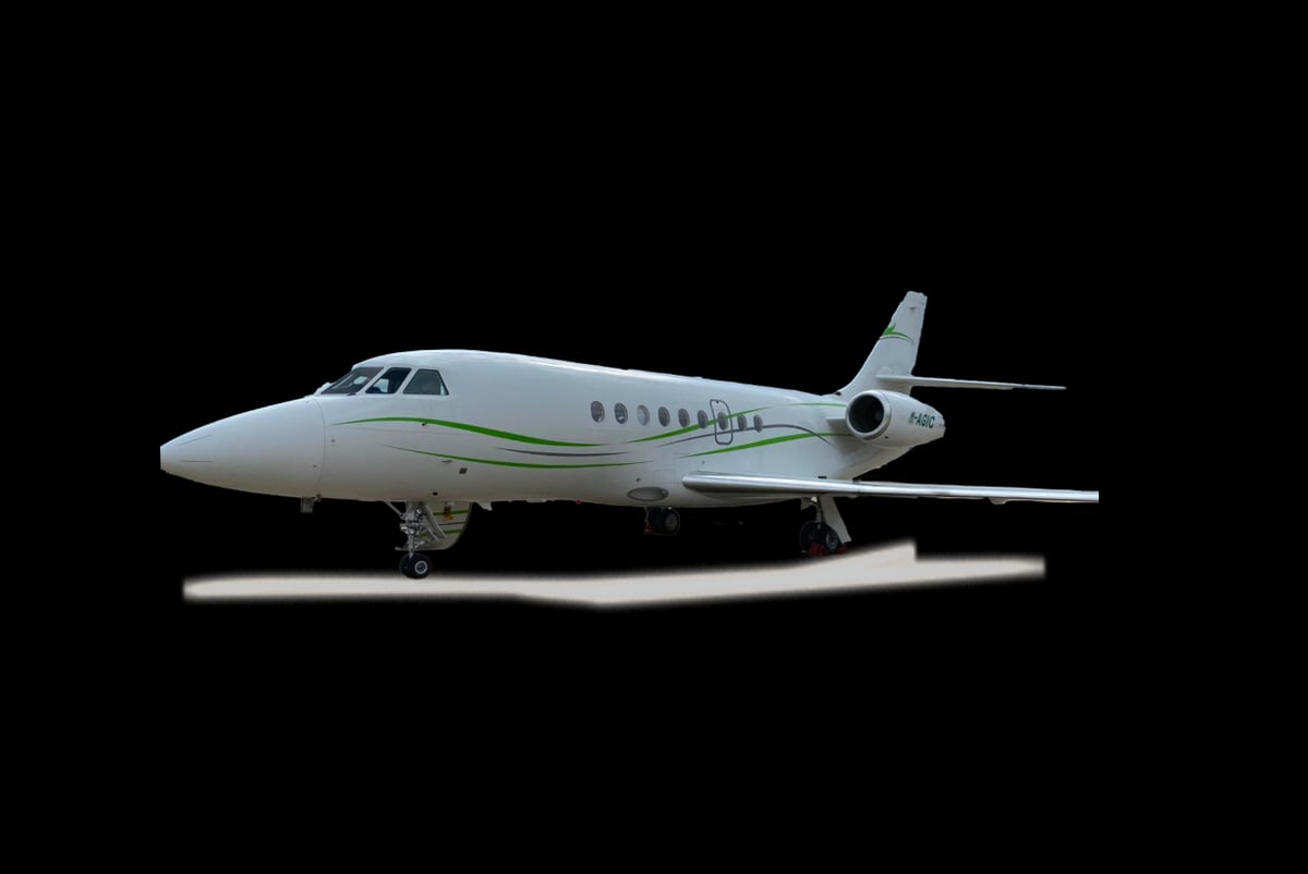 A white Dassault Falcon jet with registration N883RA against a black background.