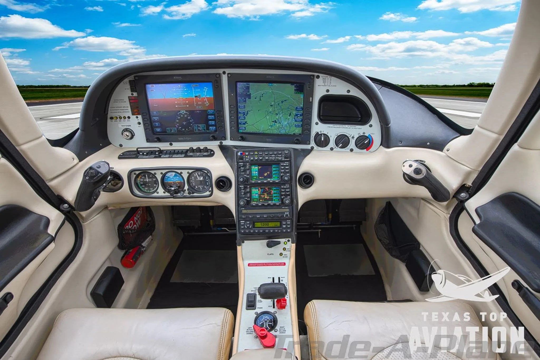 The cockpit of a Cirrus SR22 aircraft, featuring a glass panel display and traditional gauges, with a view of the runway outside.