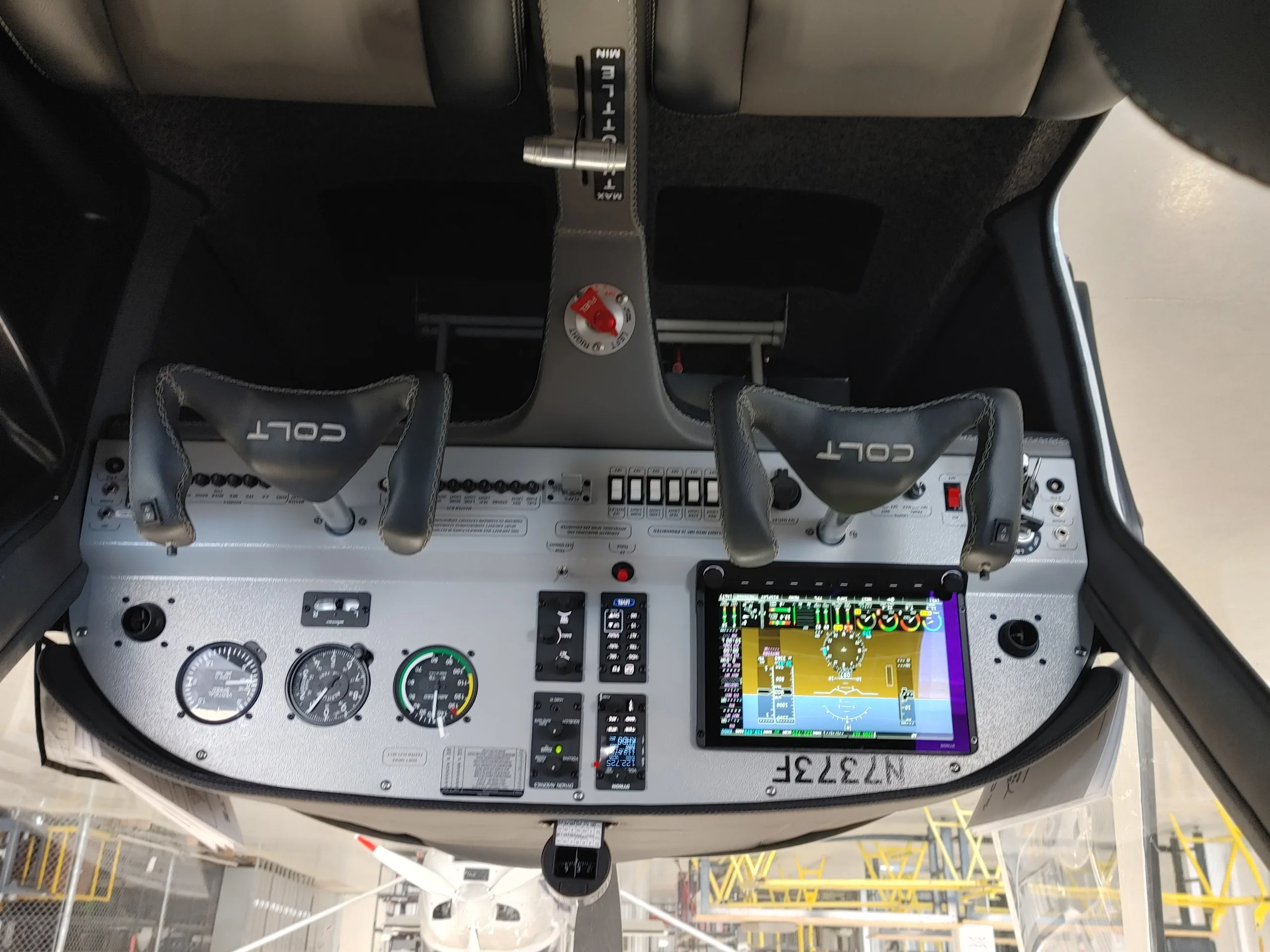 The cockpit of a Texas Aircraft Colt N7373F with a modern glass panel display and yokes.