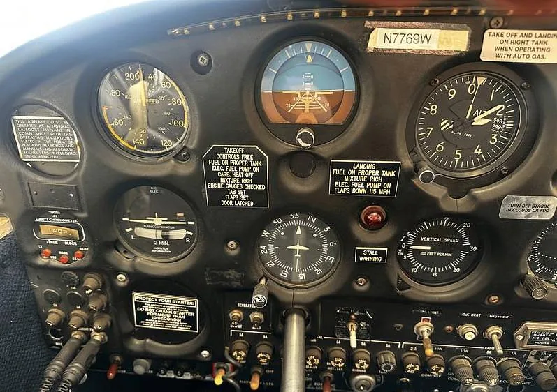 The main instrument panel of a Piper Cherokee C aircraft, showing various flight gauges and controls.