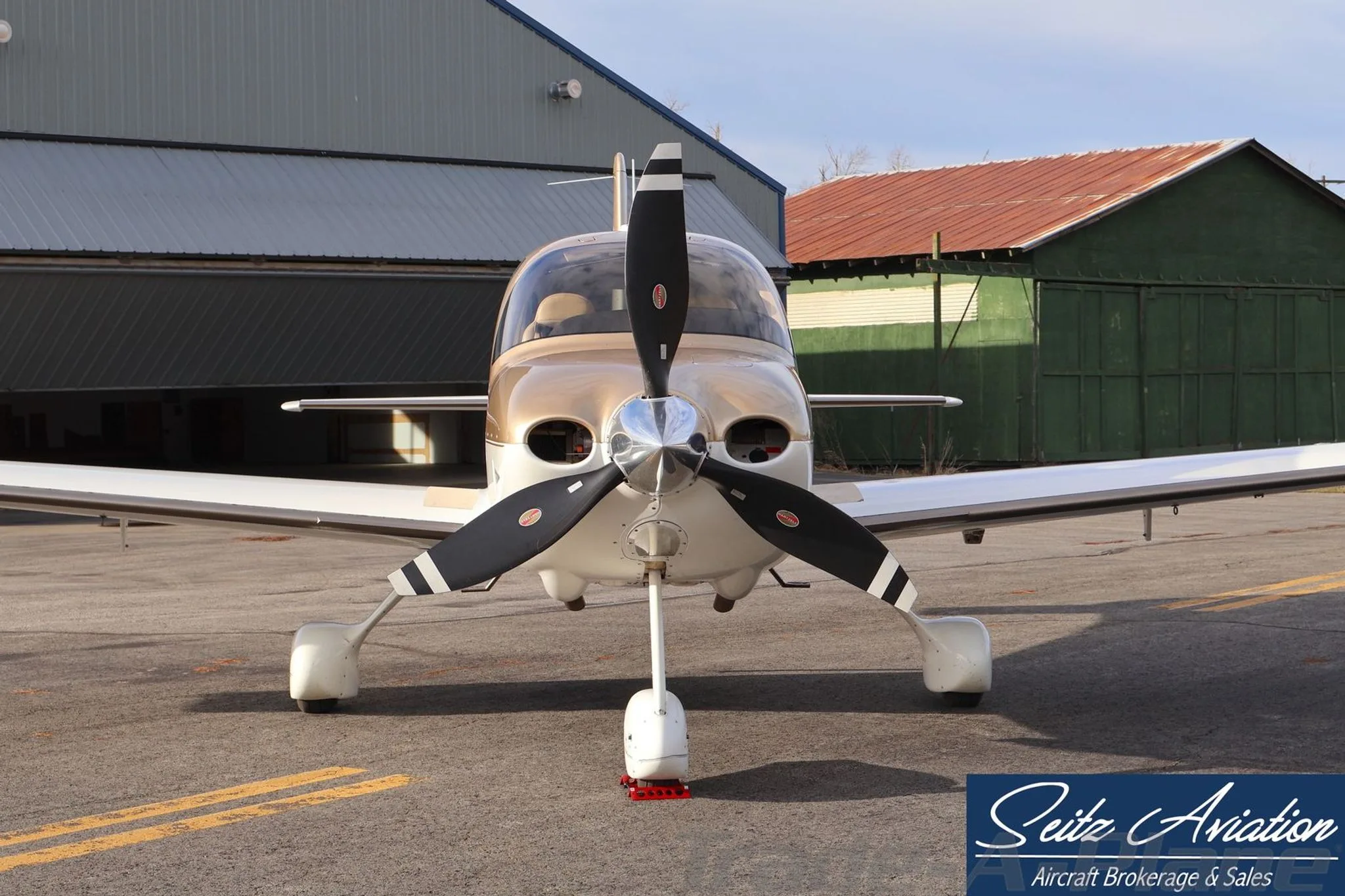 Front view of the Cirrus SR22T aircraft N822TN, showing its propeller and nose gear, parked on an asphalt ramp.
