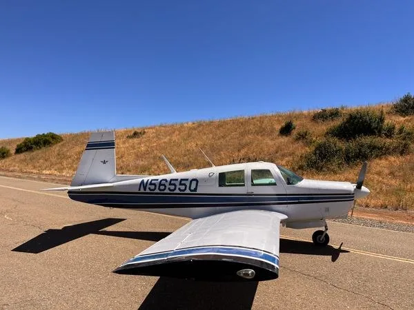A Mooney M20C parked on a road.