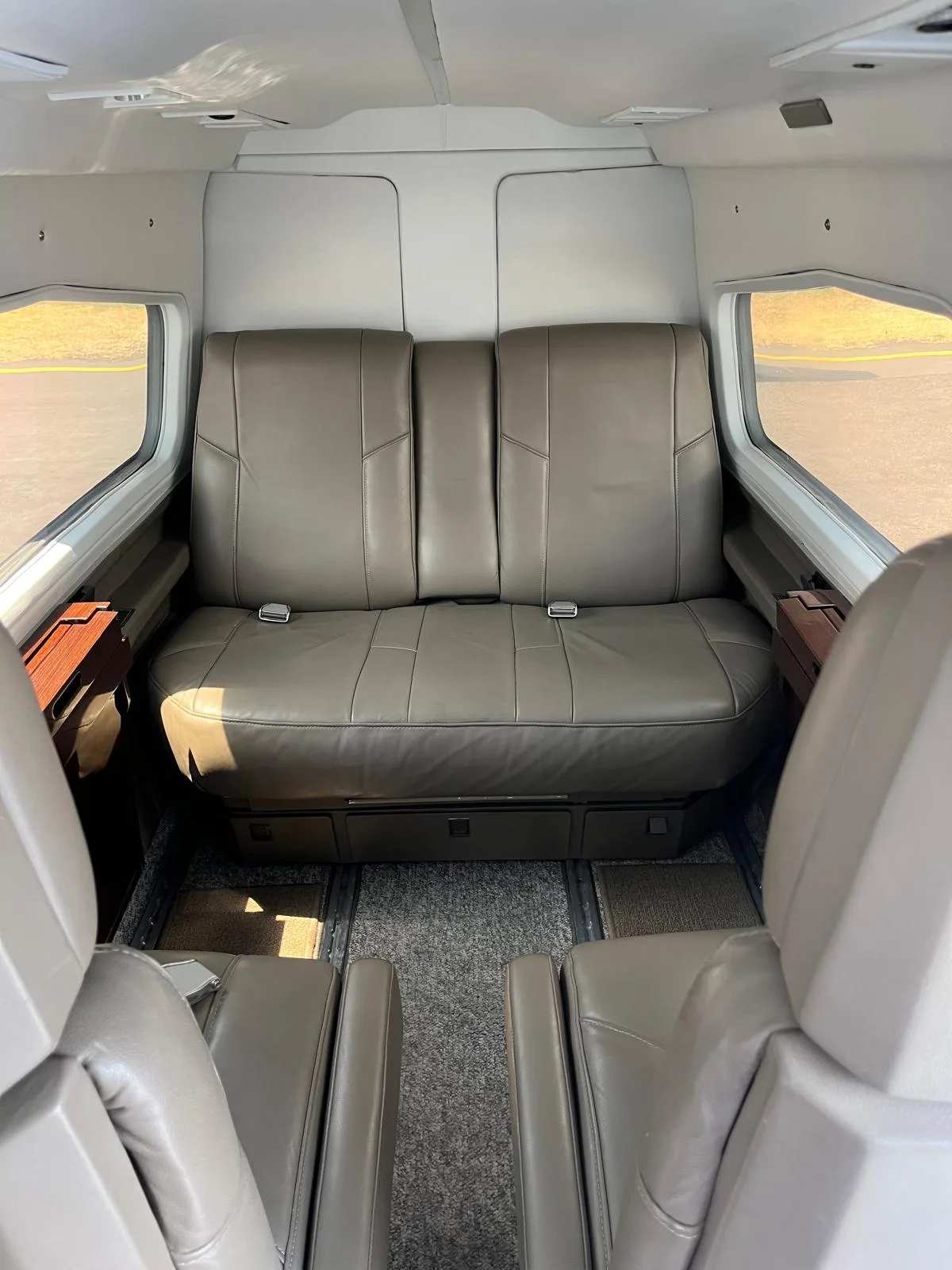 View of the aircraft's interior, showing the leather seats and carpet.