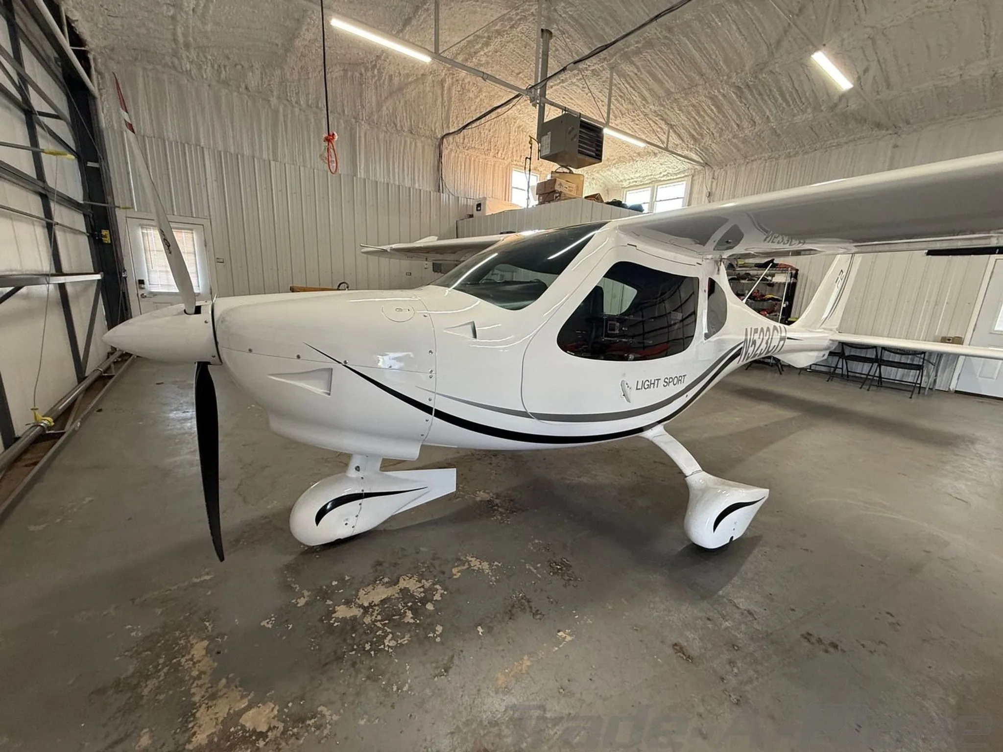 A side view of the aircraft inside a hangar.