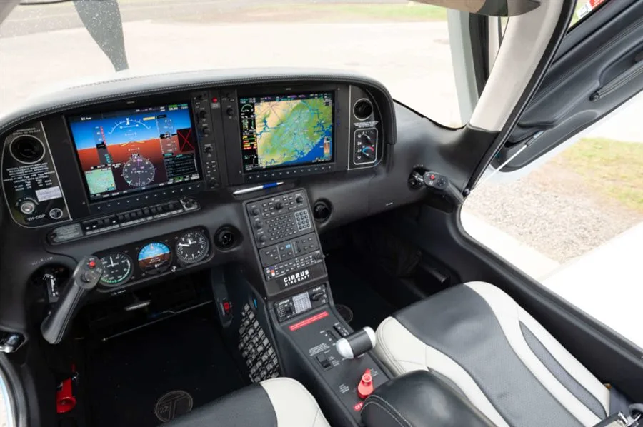 The cockpit of a Cirrus SR22T aircraft, featuring two large digital displays and a side yoke.
