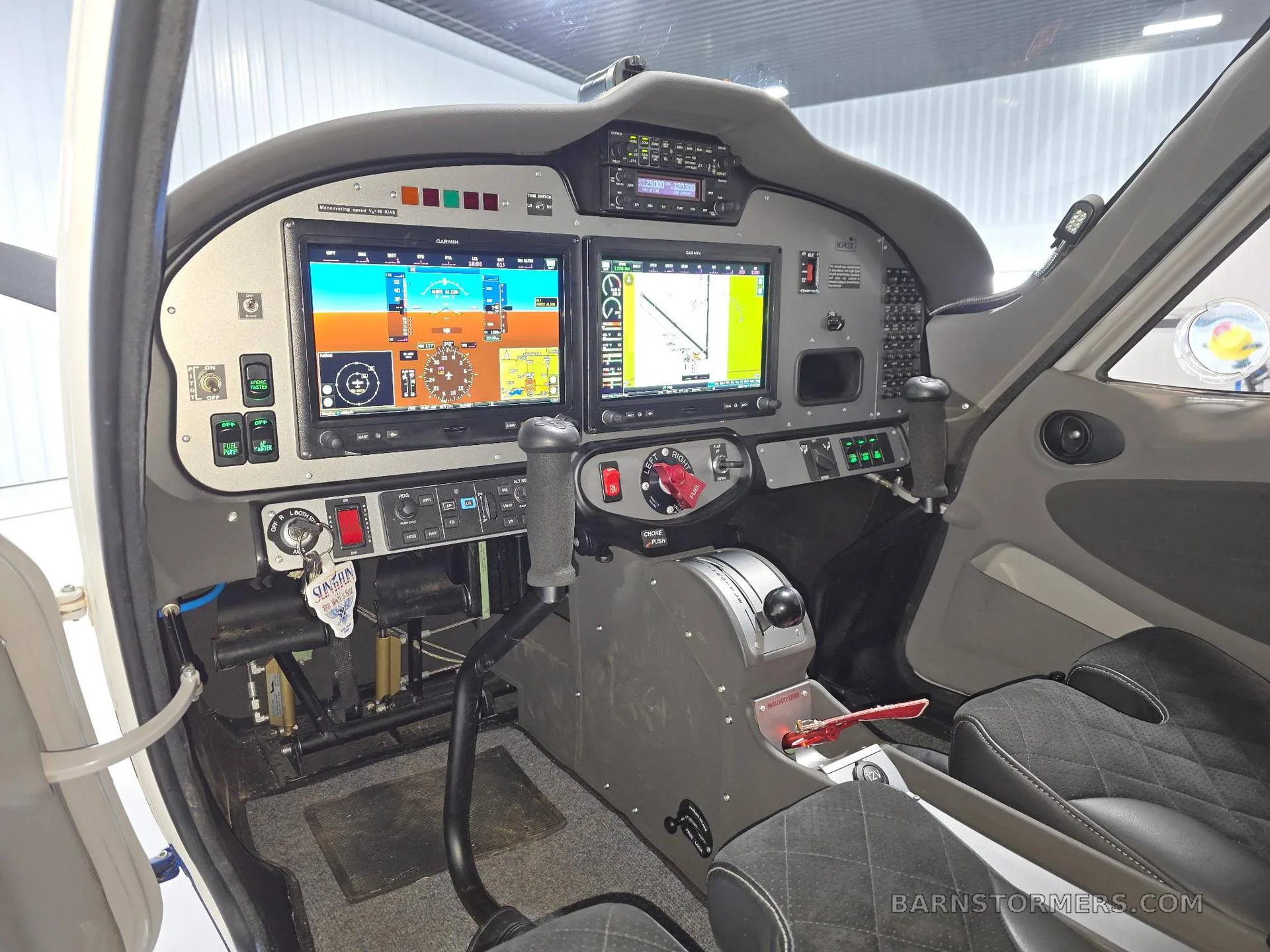 The cockpit of a Tecnam P2008 Light Sport aircraft, showing the instrument panel with dual Garmin G3X Touch displays and controls.