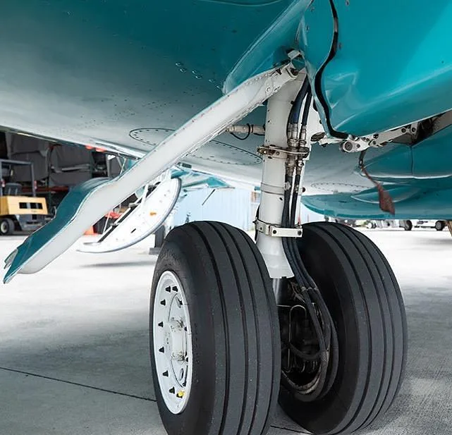 A close-up view of the main landing gear of a Hawker 800XP business jet.