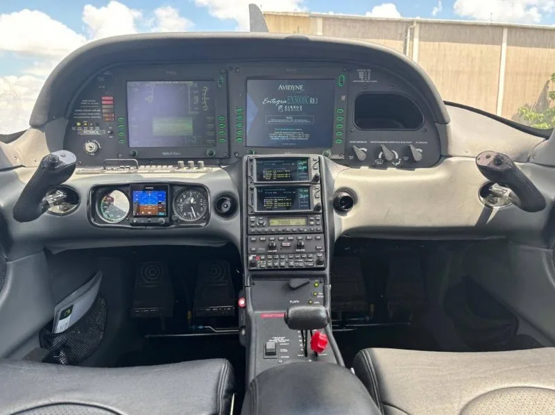 View of the cockpit dashboard with dual Avidyne Entegra glass displays and traditional radio stack.