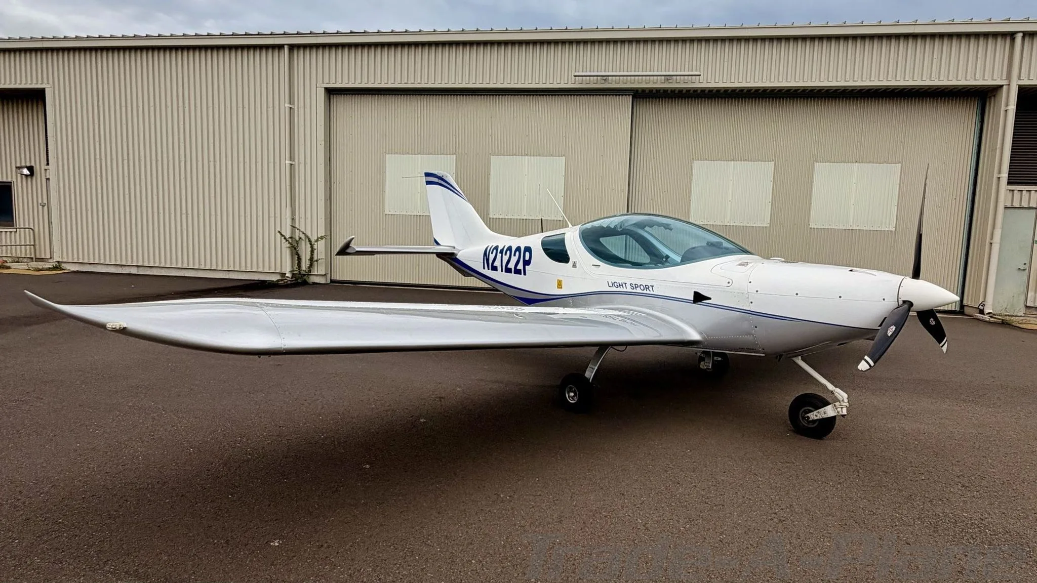 A side view of the aircraft parked on the ground.
