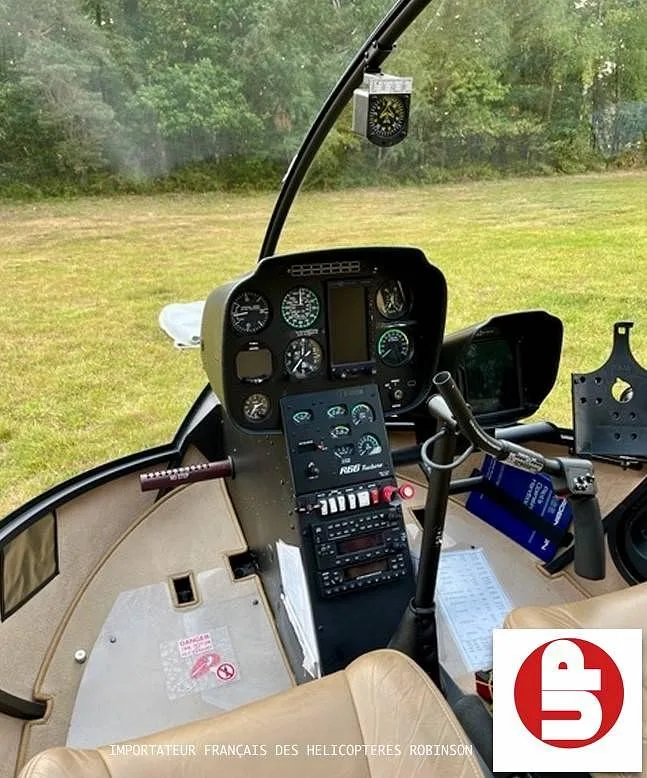 The cockpit of a Robinson R66 Turbine helicopter, showing the instrument panel and controls.