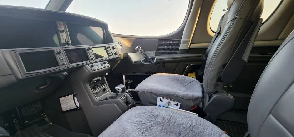 The cockpit interior of the Cirrus Vision Jet, showing the pilot's seat and instrument panel.