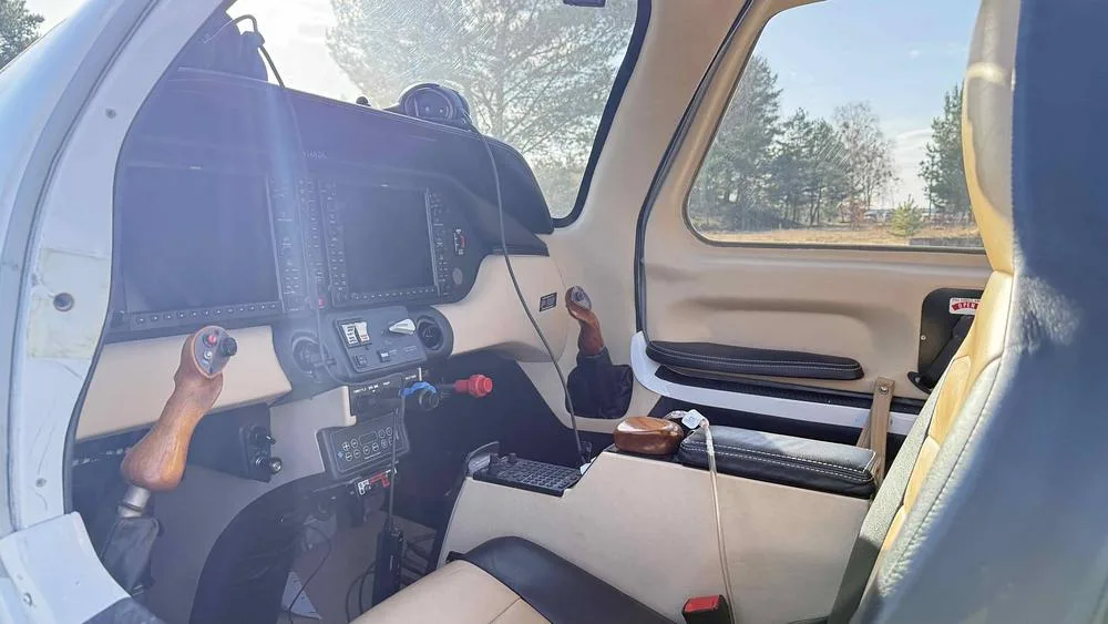 The instrument panel and controls of the Columbia 400 aircraft cockpit with dual screens.