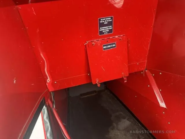 The red interior of the aircraft's cargo or baggage compartment with a "MAX LOAD 5 LBS" label.