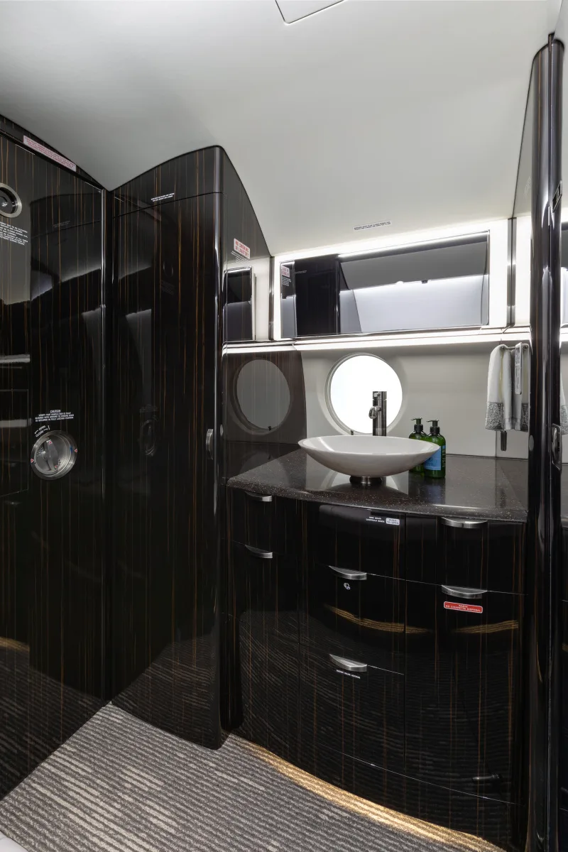 Lavatory with sink and dark wood cabinetry.