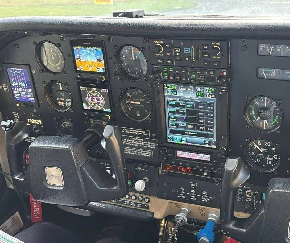 A detailed view of the aircraft's cockpit instrument panel, featuring multiple digital displays and analog gauges.