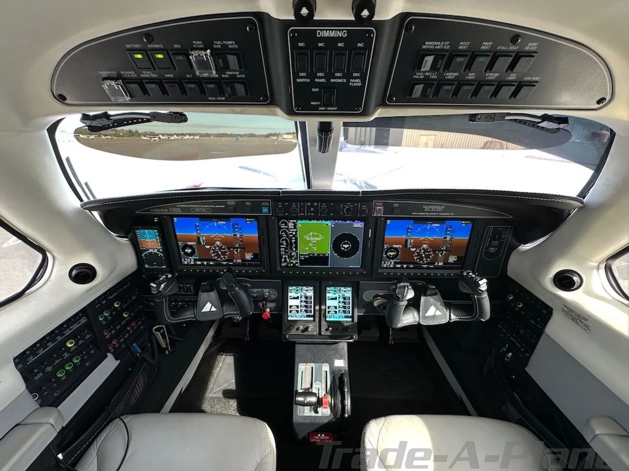 The cockpit of the Piper M600/SLS aircraft, featuring a modern glass panel display and overhead controls.