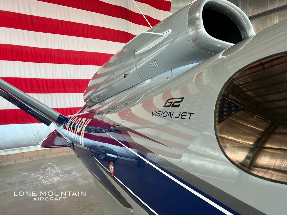 Close-up view of the engine and tail section of the Cirrus G2 Vision Jet (N33PK), showing the registration and 'VISION JET' branding.