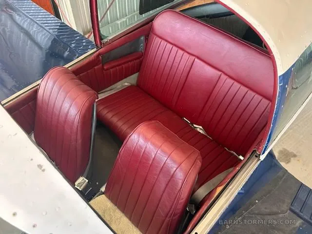 The aircraft's interior showing red leather front and rear seats.