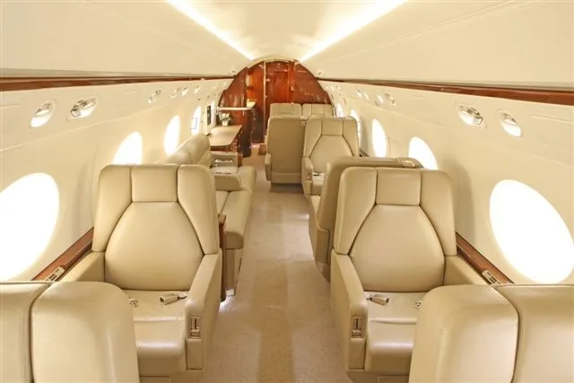 The aircraft's interior features tan leather seats.