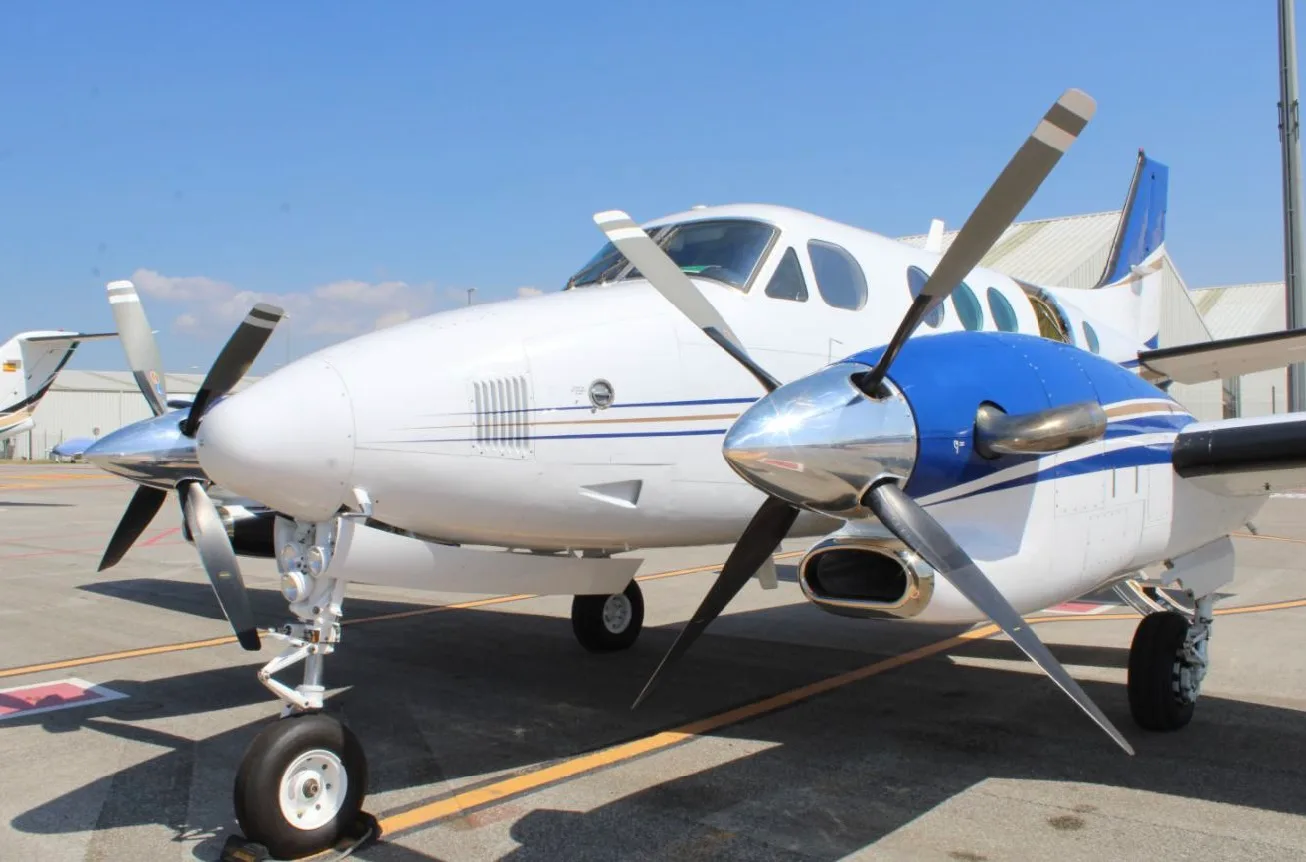 A King Air turboprop aircraft is parked on the tarmac.