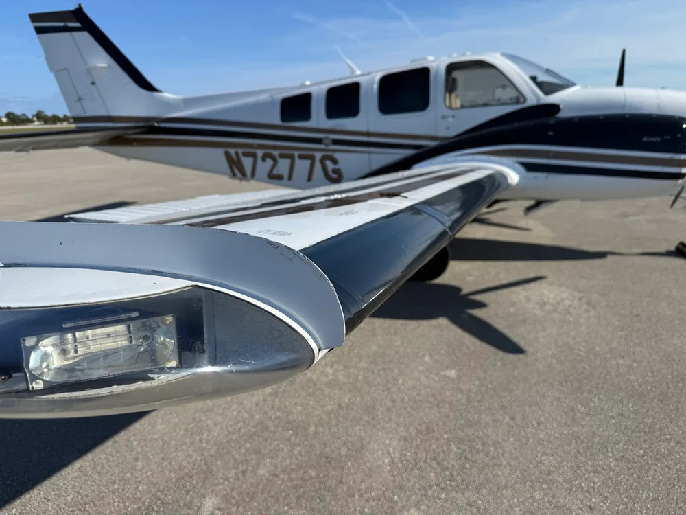 A close-up view highlights the wingtip and registration N7277G on the fuselage of the twin-engine aircraft.