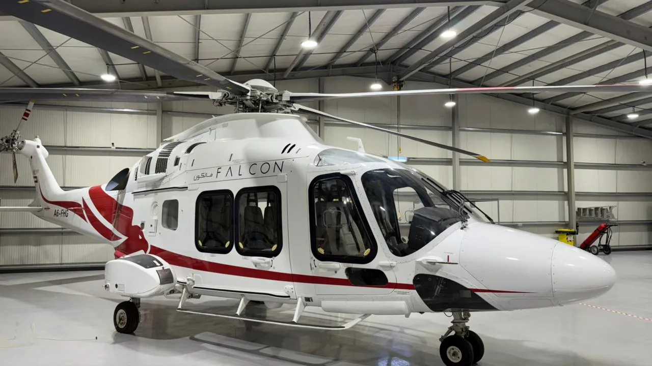 Close-up of the A6-FHG helicopter showing the cockpit and cabin windows.