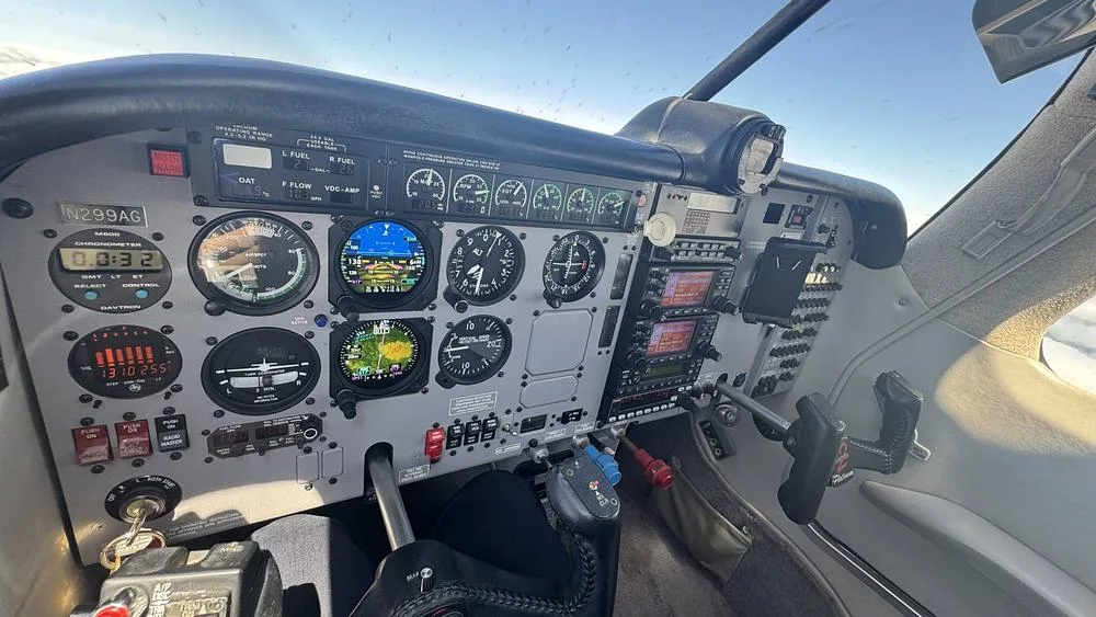 The cockpit of the N299AG aircraft, showing the instrument panel with various gauges, screens, and controls.