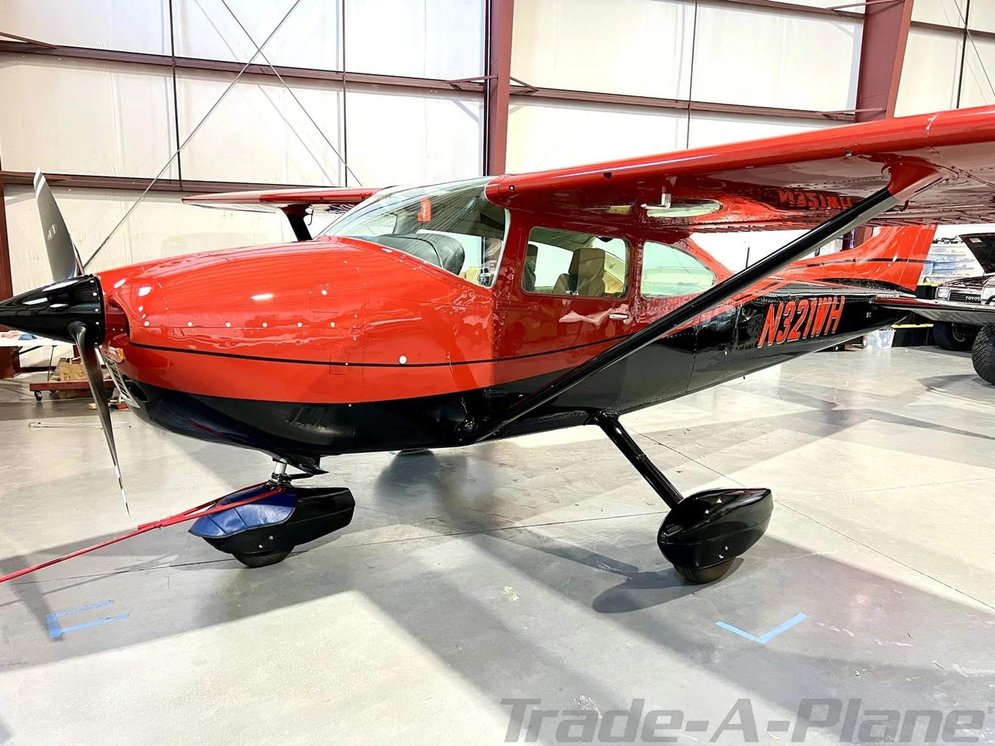 A side view of the Cessna 182Q Skylane in a hangar.