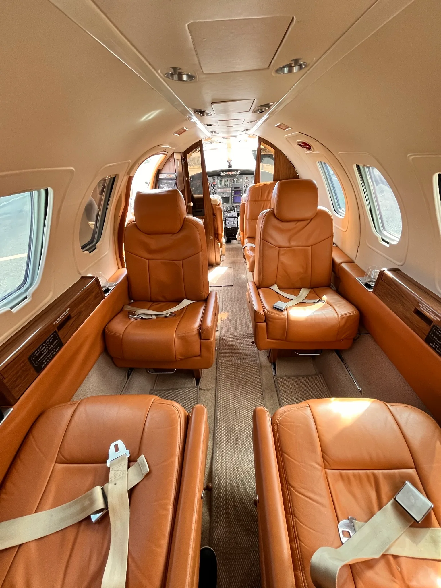 Forward view of the Cessna Citation Mustang cabin with tan leather seats.