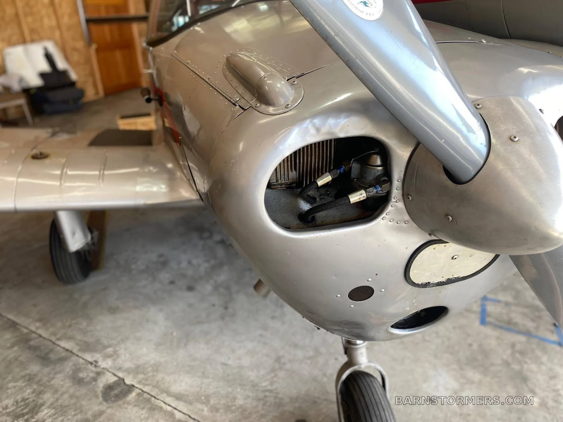 A close-up view of the silver Ercoupe aircraft's nose, propeller, and an air intake vent.