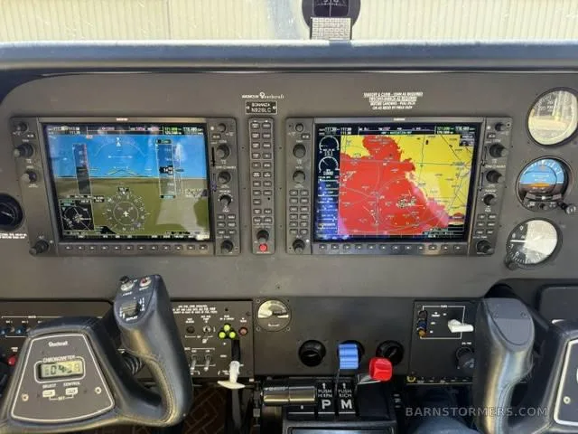 The cockpit instrument panel of a Beechcraft Bonanza N926LC, featuring two large glass displays and traditional controls.