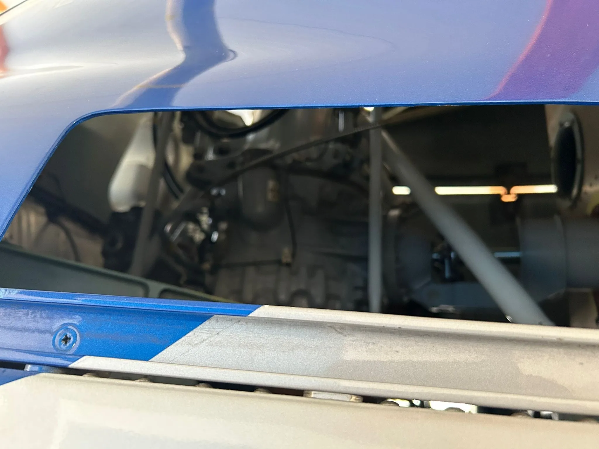 Close-up view of the engine compartment of an Airbus H120 Colibri helicopter with a panel open.