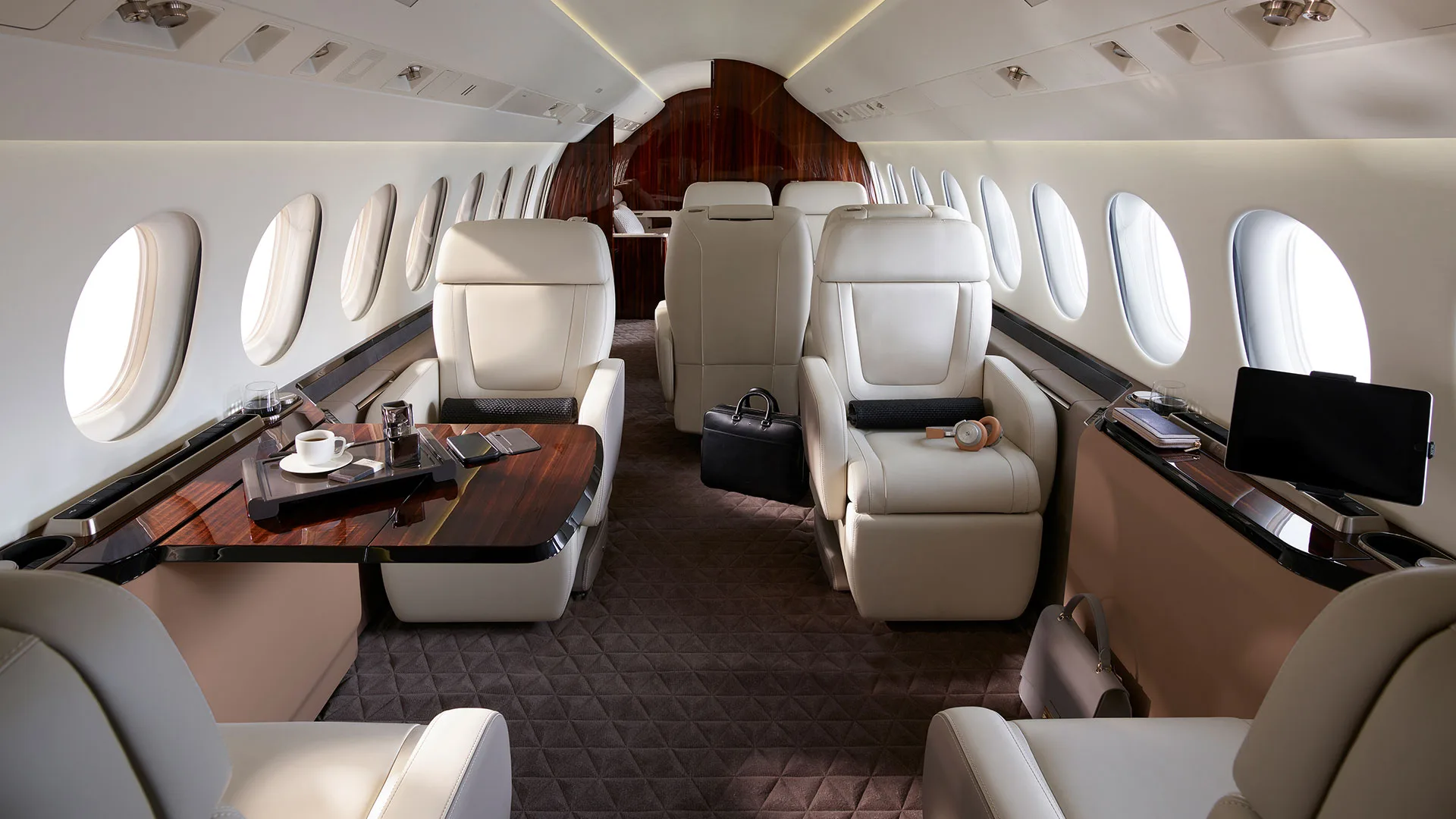 View of the aircraft cabin with leather seats and wood trim.