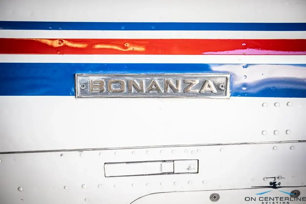 Close-up of the 'Bonanza' emblem on the side of the aircraft.