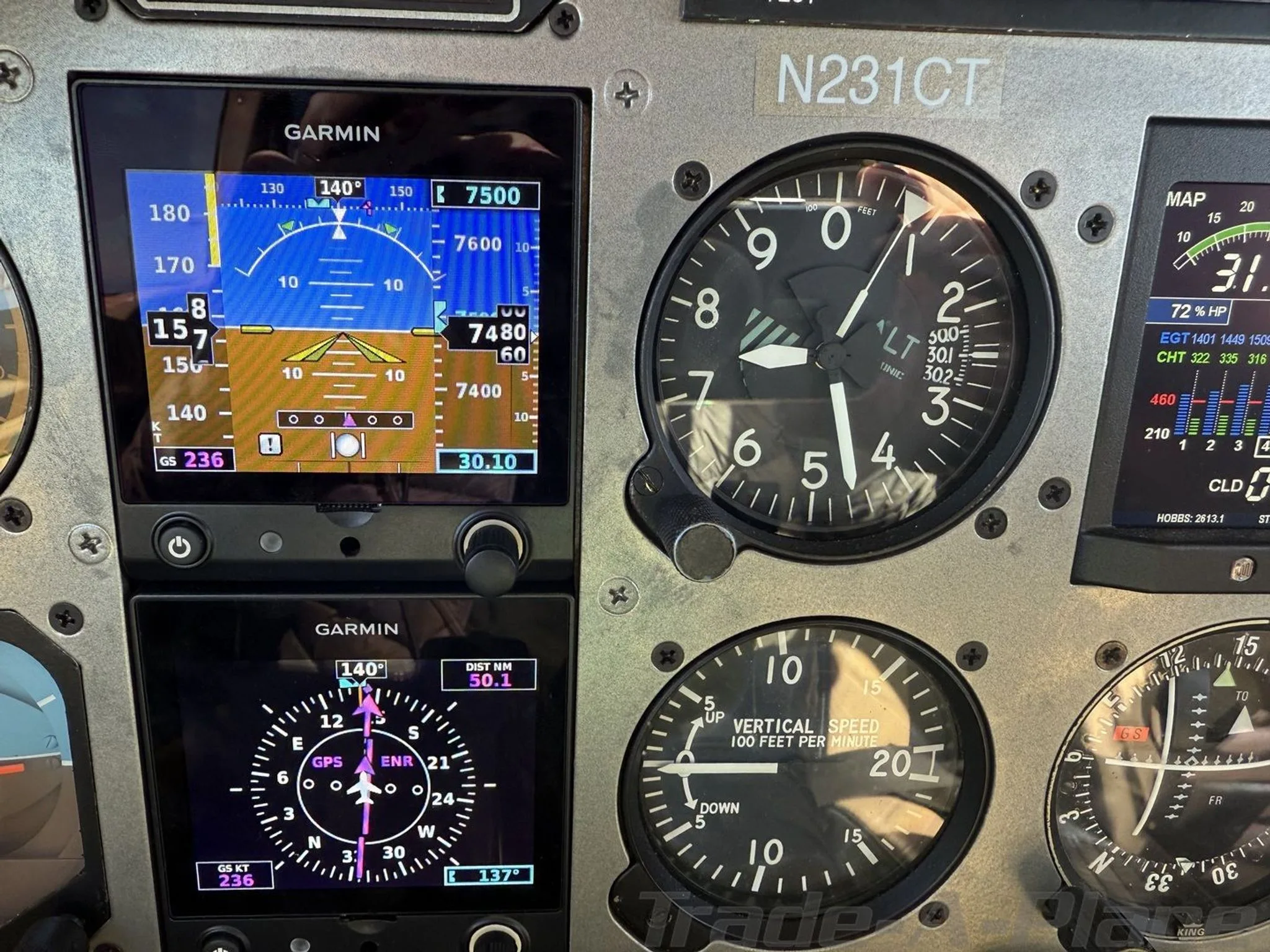 Close-up of the aircraft's Garmin primary flight display, altimeter, and vertical speed indicator.