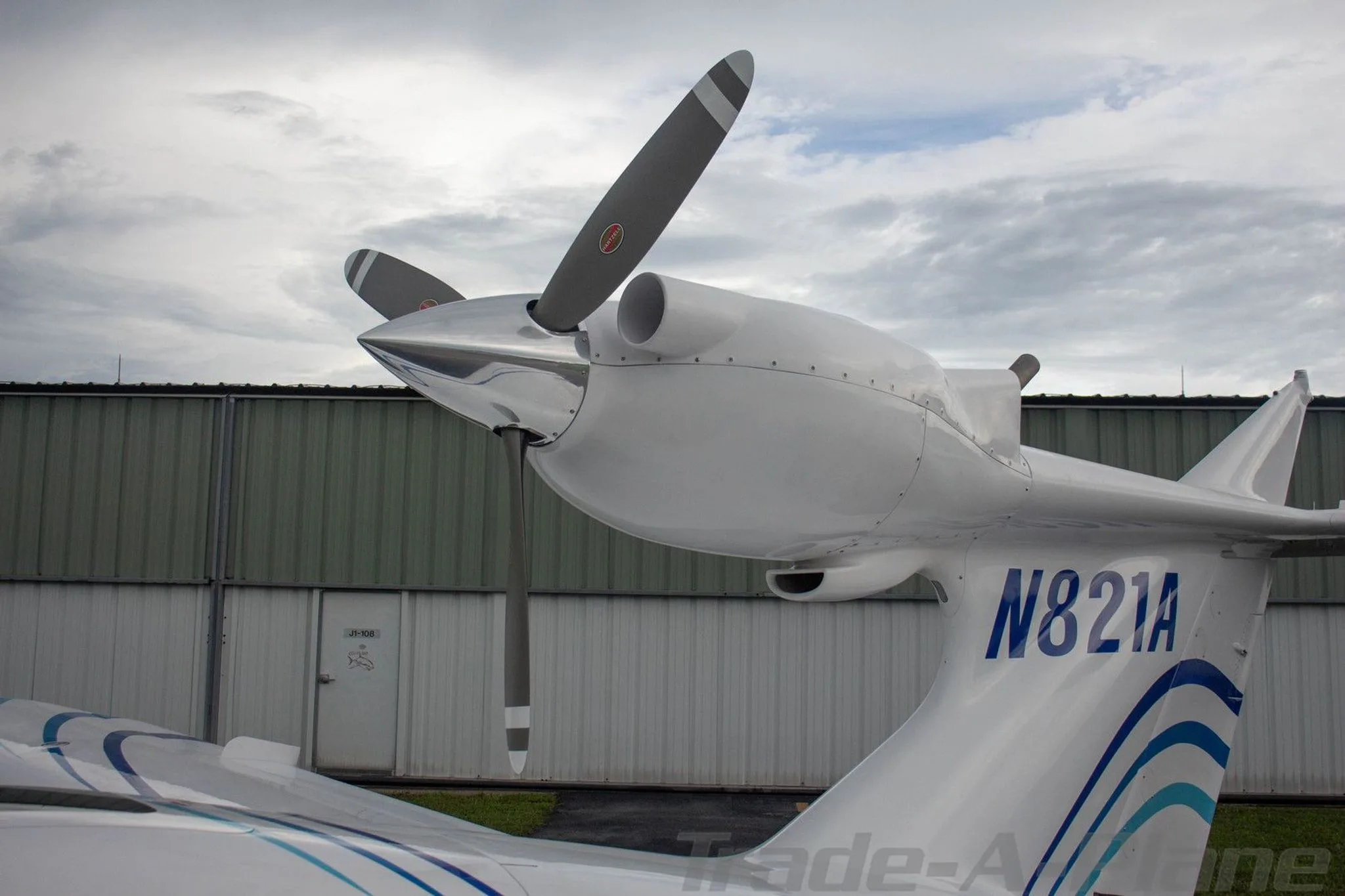 A close-up view of the tail and pusher propeller of the white Searey amphibian aircraft, showing registration N821A.