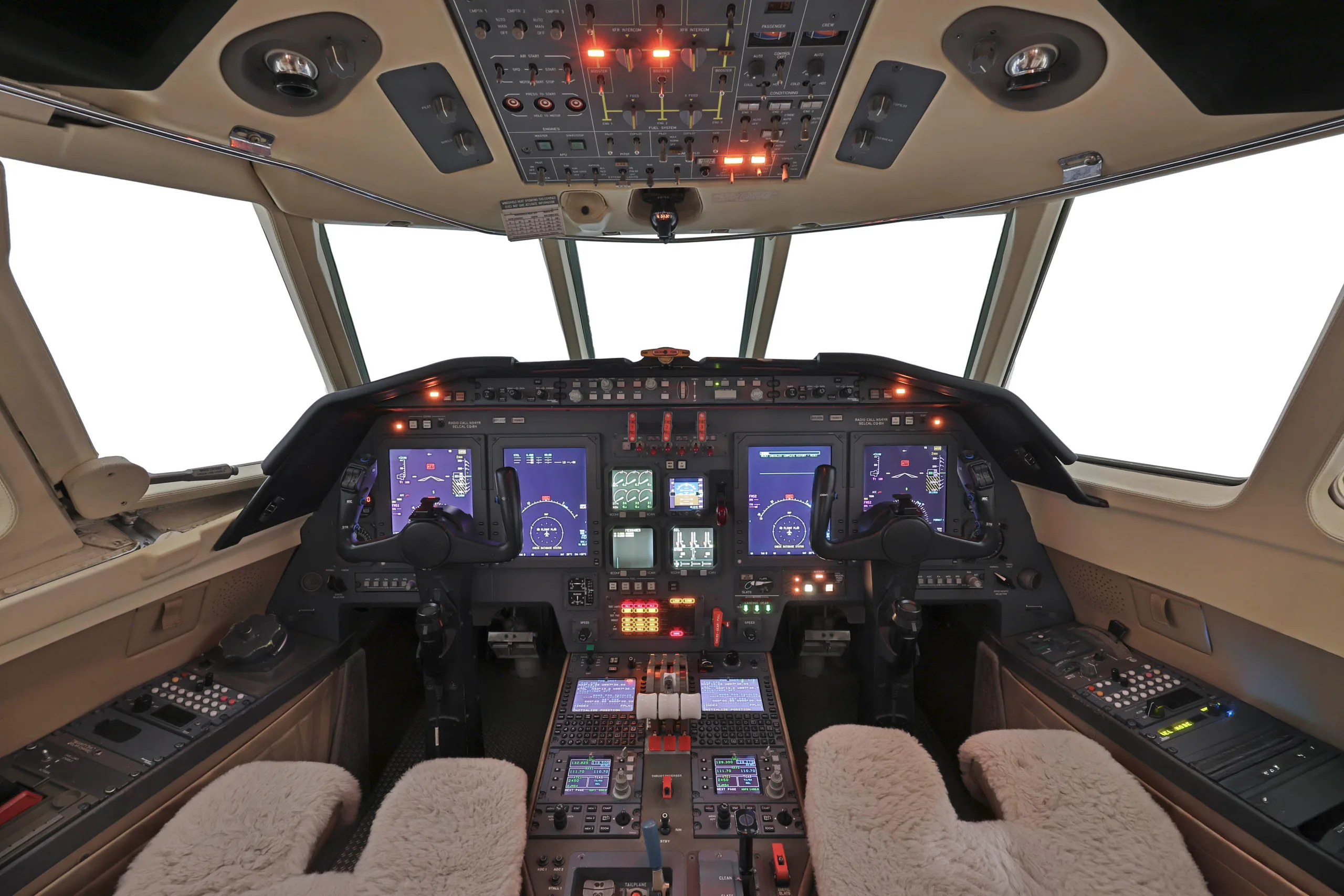 The aircraft's cockpit shows multiple digital displays and a complex array of control panels.